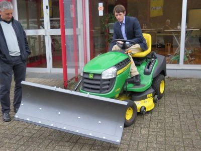 Ride-on mower fitted with a Kersten front snow plough for winter contractor work