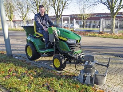Ride-on mower fitted with a Kersten weed brush for productive path and hard-surface maintenance