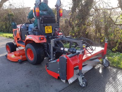 Kersten HKM 15040 rear-mounted sweeper operating behind a compact tractor