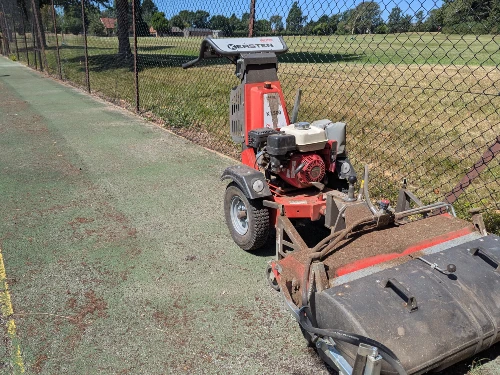 Kersten sweeper working on a painted tennis court