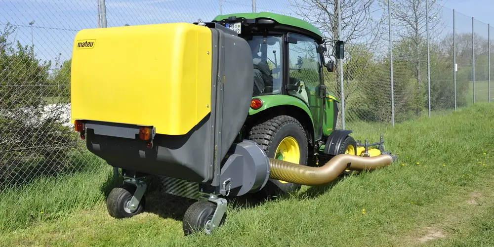 Matev CLS tractor mounted collection system working on a large grassed site